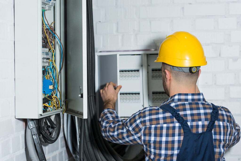 Male electrician repairing circuit line